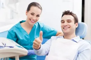 dentist and patient giving thumbs up
