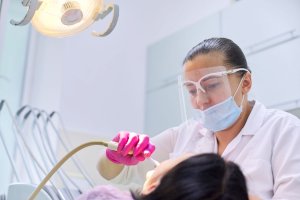 dental hygienist with patient